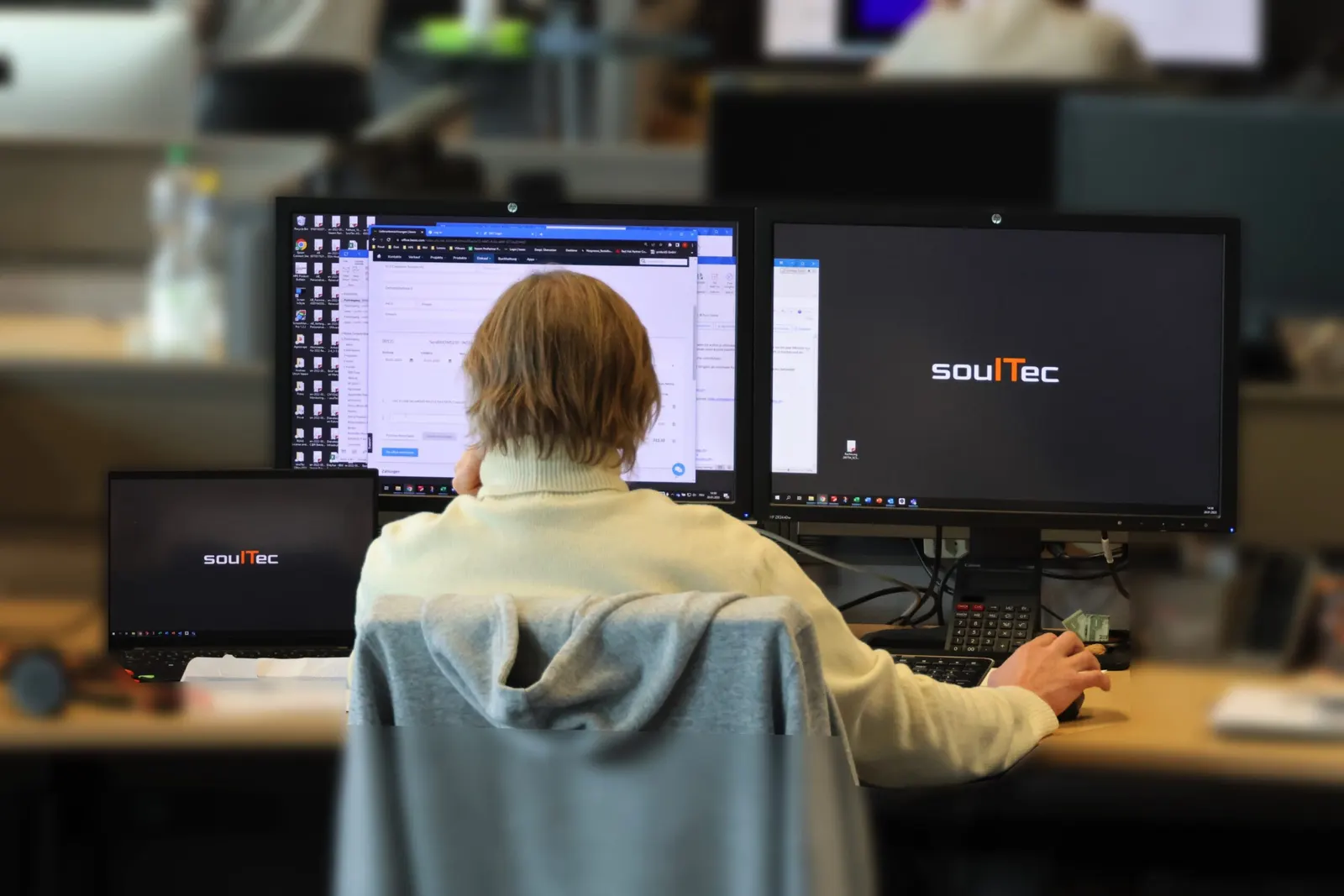 A desk with a soulTec-branded monitor