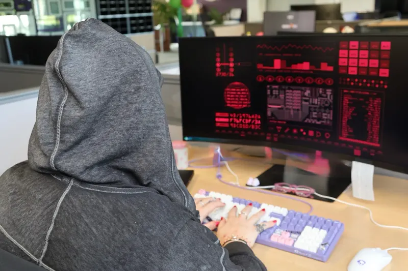 An engineer reading a monitoring dashboard on a dark screen