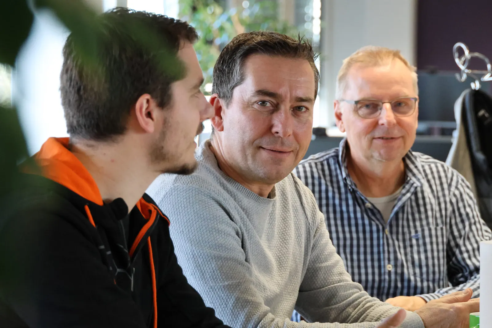 Three soulTec engineers looking at one screen together